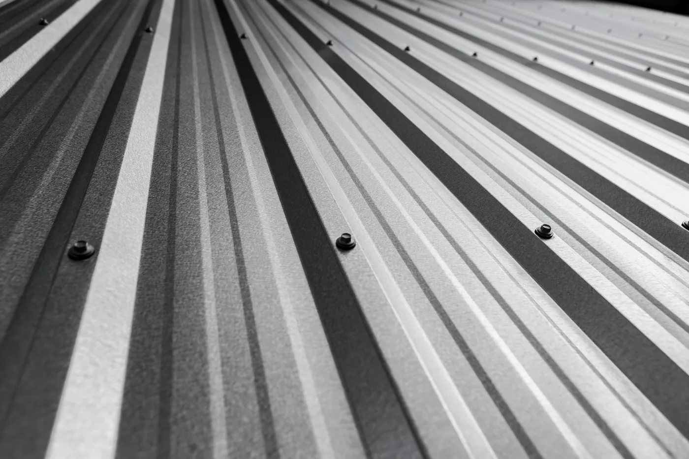 PBR profile metal panel ribs in diagonal light — wall and roof panels made in Texas